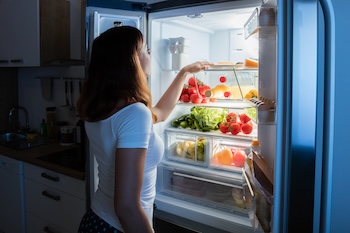 woman looking in fridge